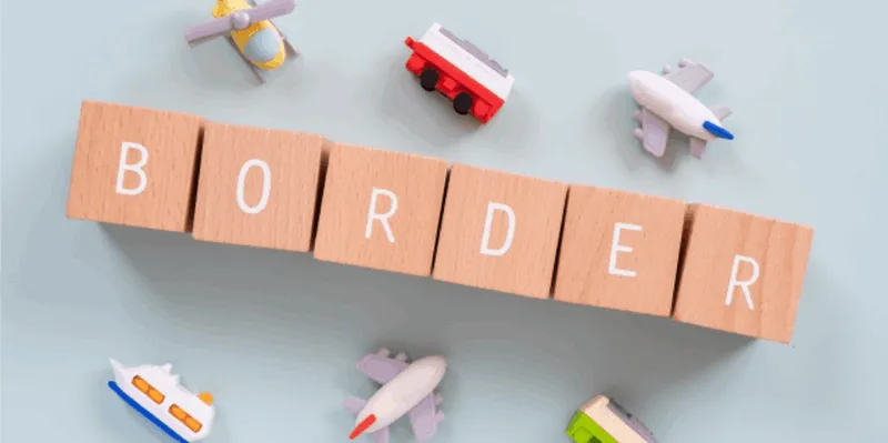 木製ブロックのBORDER文字と配送アイコンで越境ECを表現